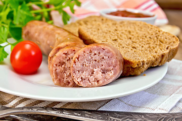 Image showing Sausages pork grilled in plate with bread on napkin