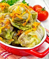 Image showing Cabbage stuffed and carrots in red pan on board