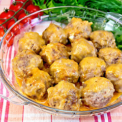 Image showing Meatballs with sauce in glass pan on fabric