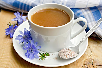 Image showing Chicory drink in white cup with flower and spoon on board