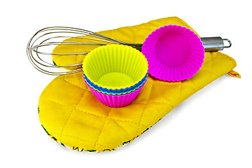 Image showing Molds for cupcakes with mixer on yellow potholder