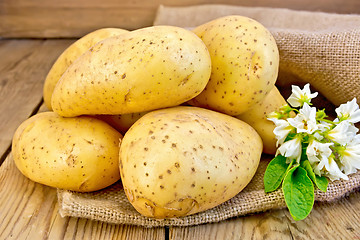 Image showing Potatoes yellow with flower on sacking