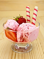 Image showing Ice cream strawberry in glass goblet on board