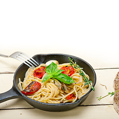 Image showing spaghetti pasta with baked cherry tomatoes and basil 