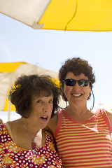 Image showing two senior women friends happy at beach