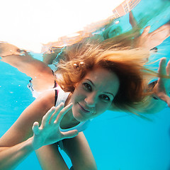 Image showing Female with eyes open underwater