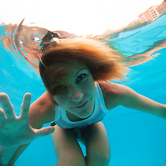 Image showing Female with eyes open underwater