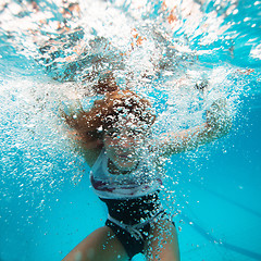 Image showing Female underwater with face surrounded by bubbles