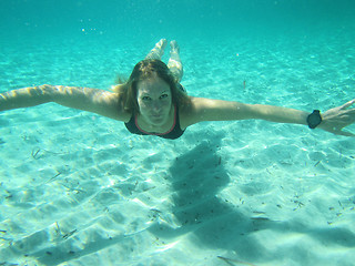 Image showing Female with eyes open underwater in ocean