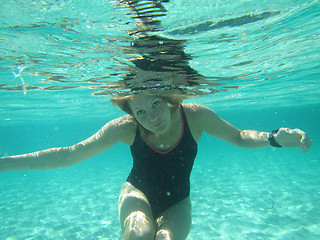 Image showing Female with eyes open underwater in ocean