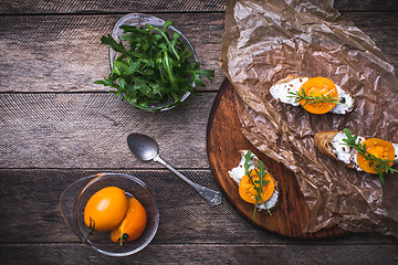 Image showing Bruschetta with cheese, tomatoes and salad rocket in rustic styl