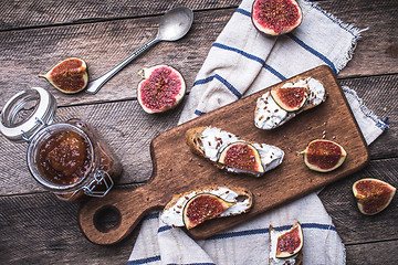 Image showing Bruschetta snacks with jam and figs on napkin in rustic style