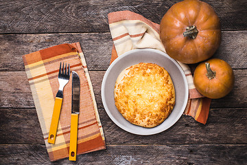 Image showing Rustic style pumpkins and flat cake on wooden table