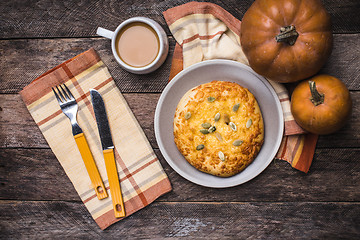 Image showing Breakfast coffee and flat cake with pumpkin seeds on wooden tabl