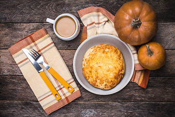Image showing Pumpkins, coffee and flat cake on wooden table