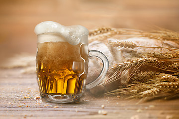 Image showing Bread and wheat on wooden table, shallow DOF