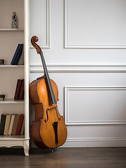 Image showing Cello in classical interior with bookshelf