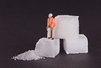 Image showing Miniature worker working on a sugar cube