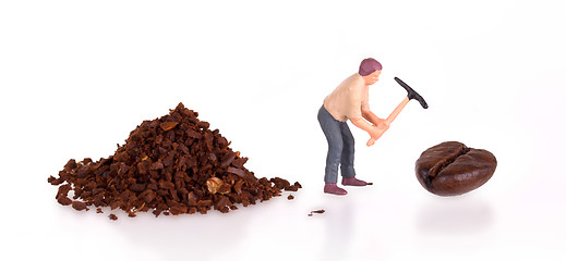 Image showing Miniature worker working on a coffee bean