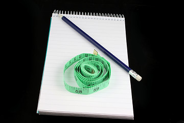 Image showing Notepad Pencil and tape measure