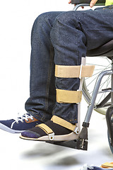 Image showing Orthopedic equipment for young man in wheelchair - close up