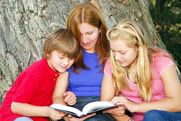 Image showing Family reading a book