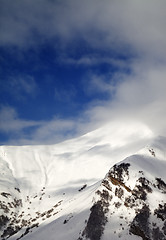 Image showing View on off-piste sunlight slope in clouds