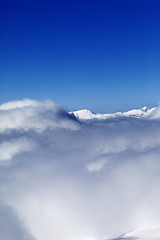 Image showing Mountains under clouds and clear sunny sky