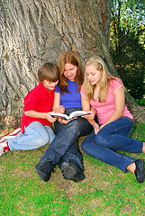 Image showing Family reading a book