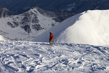 Image showing Skier on off-piste slope in sun evening