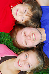 Image showing Family lying down on grass