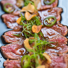 Image showing Beef Carpaccio on dark background