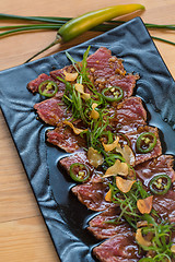 Image showing Beef Carpaccio on dark background