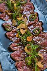 Image showing Beef Carpaccio on dark background