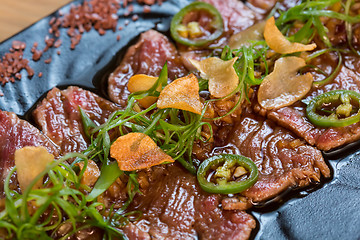 Image showing Beef Carpaccio on dark background