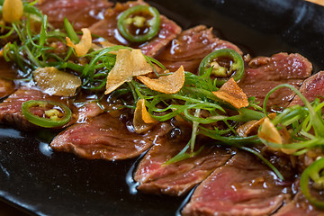 Image showing Beef Carpaccio on dark background