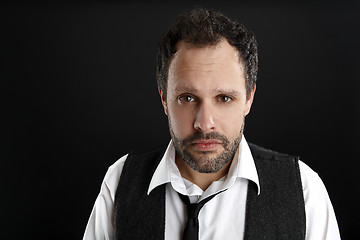 Image showing Attractive  man with white shirt and black tie looks into the ca