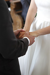 Image showing Hands of a bride and a groom holding each other