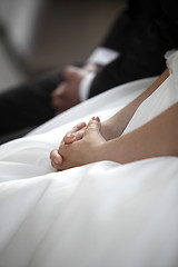 Image showing Hands of a bride and a groom praying