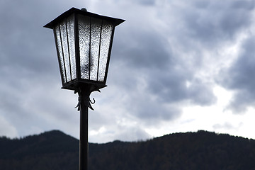 Image showing Street lamp in front of mountains