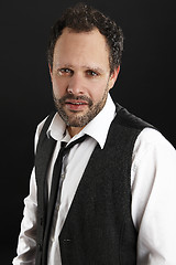 Image showing Attractive  man with white shirt and black tie looks into the ca