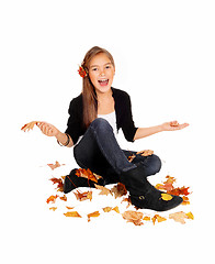 Image showing Happy girl with falling leaves.