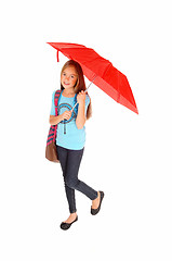 Image showing Young girl standing with umbrella.