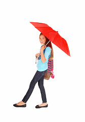 Image showing Young girl walking with umbrella.