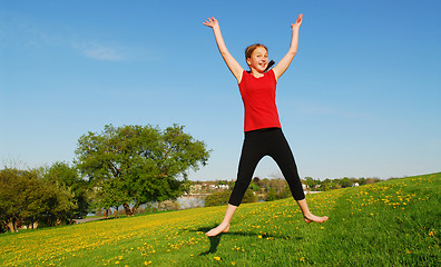 Image showing Young girl jumping