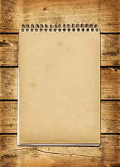 Image showing Blank vintage notebook on a wood board