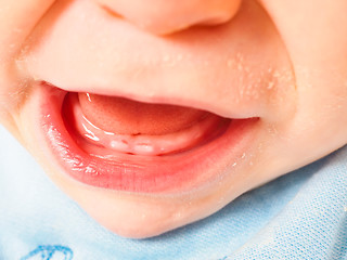 Image showing Baby boy showing first teeth with mouth wide open