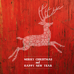 Image showing Christmas Deer Silhouette On Red Planks Texture. Vector