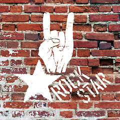 Image showing Rockstar symbol with sign of the horns gesture. Vector template 