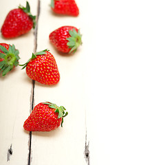 Image showing fresh organic strawberry over white wood